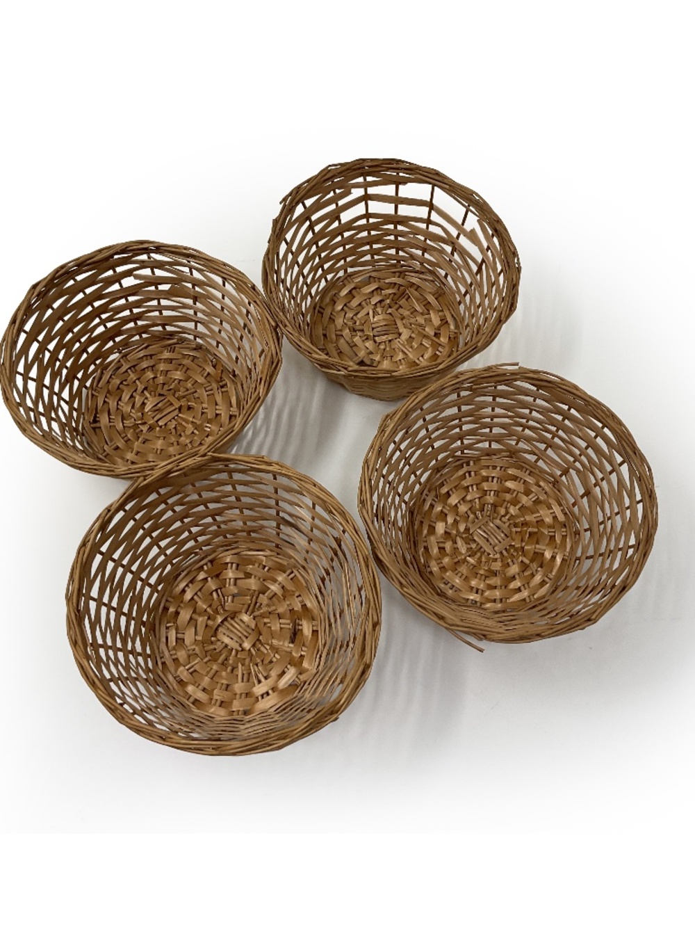 four small vintage round wicker woven wicker baskets with an open-lattice design